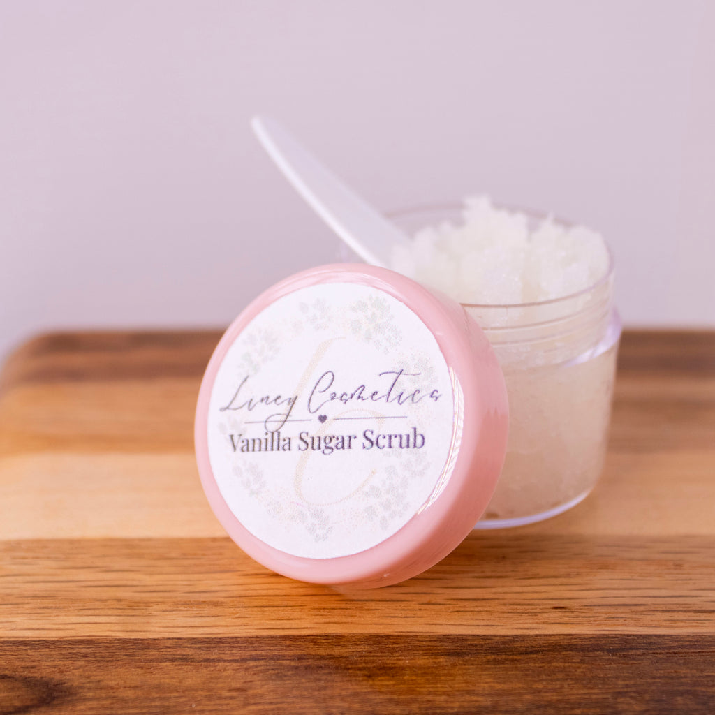 A small jar of Liney Cosmetics Vanilla Lip Scrub with a small spoon sitting in the jar.